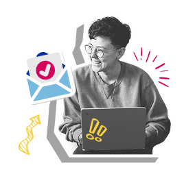 A smiling woman with glasses works on a laptop, conveying a sense of joy and productivity.